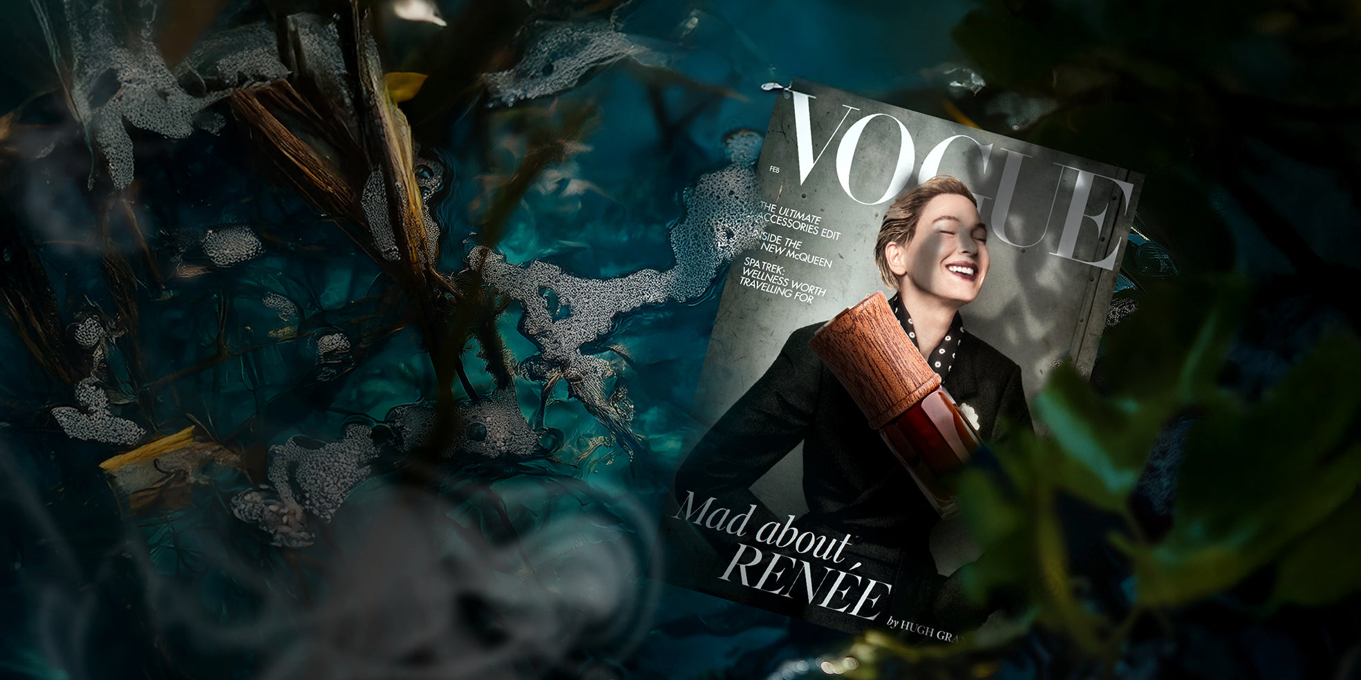 A Vogue magazine featuring Renée Zellweger lies partially submerged in water surrounded by green leaves and bubbles. A luxury SULAYM fragrance bottle with a wooden cap on the cover, highlighting the feature of SULAYM in vogue magazine, blending high fashion with artisanal perfumery.